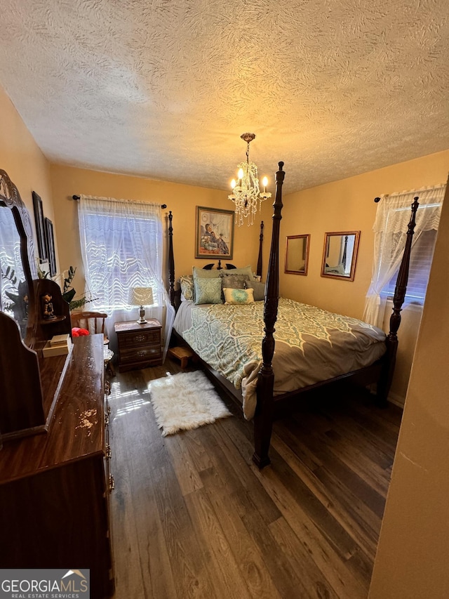 2019 Cason Dr, Vidalia, GA 30474 - bedroom with wood finished floors, a chandelier, and a textured ceiling