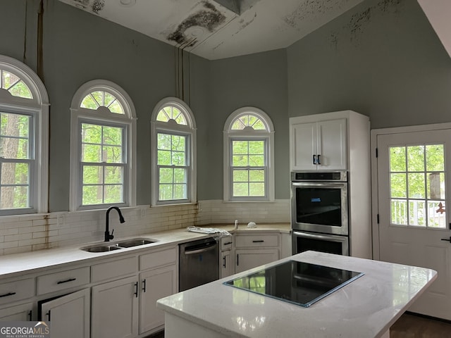 730 Redlion Run, Alpharetta, GA 30022 - kitchen featuring dishwashing machine, black electric cooktop, double oven, a sink, and a kitchen island