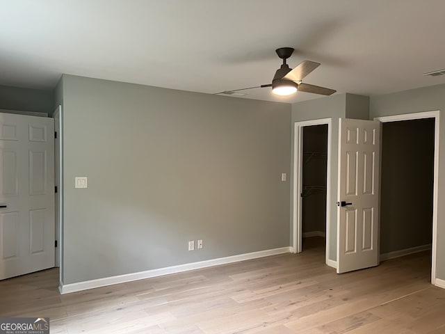 730 Redlion Run, Alpharetta, GA 30022 - unfurnished bedroom with light wood finished floors, baseboards, a closet, a spacious closet, and ceiling fan