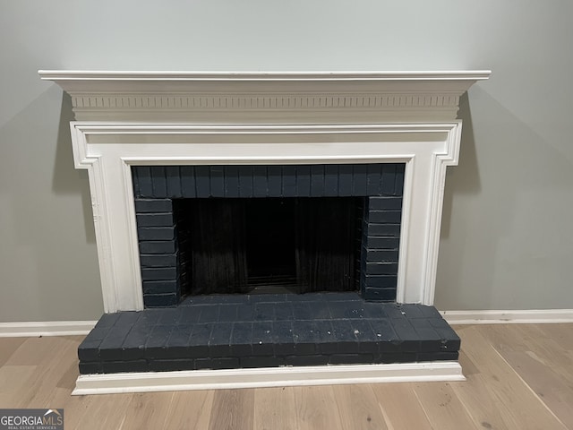 730 Redlion Run, Alpharetta, GA 30022 - detailed view of a fireplace with raised hearth, baseboards, and wood finished floors