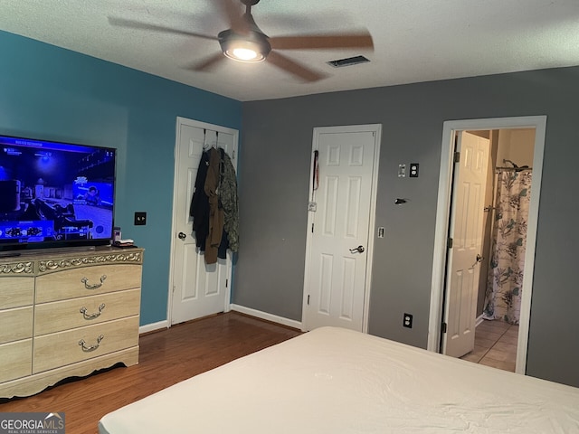 102 Driftwood Ct, Kingsland, GA 31548 - bedroom featuring dark wood-style flooring, ensuite bath, ceiling fan, and baseboards