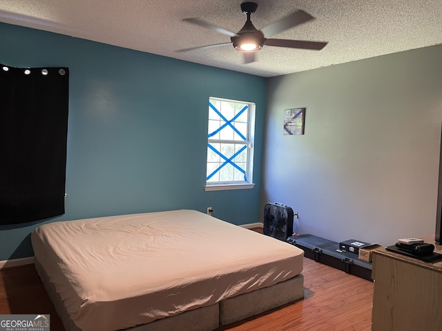 102 Driftwood Ct, Kingsland, GA 31548 - bedroom with wood finished floors, a textured ceiling, and a ceiling fan