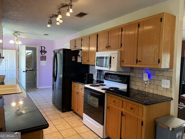 102 Driftwood Ct, Kingsland, GA 31548 - kitchen featuring range with electric cooktop, white microwave, dark countertops, tasteful backsplash, and a textured ceiling
