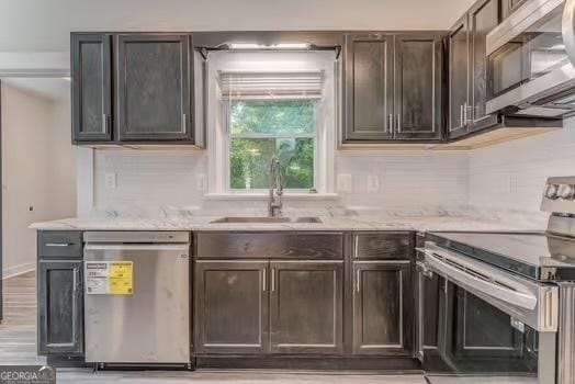 2 E 10th St SW, Rome, GA 30161 - kitchen featuring stainless steel appliances, a sink, dark brown cabinets, and light stone counters