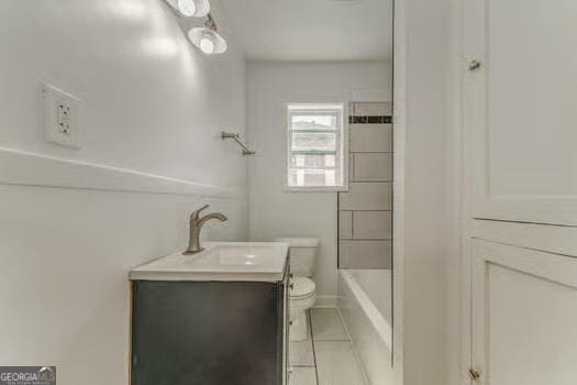 2 E 10th St SW, Rome, GA 30161 - bathroom with vanity, toilet, tile patterned flooring, and washtub / shower combination