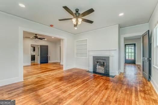 2 E 10th St SW, Rome, GA 30161 - unfurnished living room featuring ceiling fan, a fireplace with flush hearth, wood finished floors, baseboards, and recessed lighting