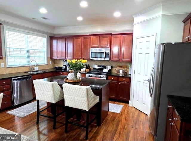 779 Avonley Creek Trce, Buford, GA 30518 - kitchen featuring appliances with stainless steel finishes, reddish brown cabinets, dark wood-style floors, backsplash, and ornamental molding