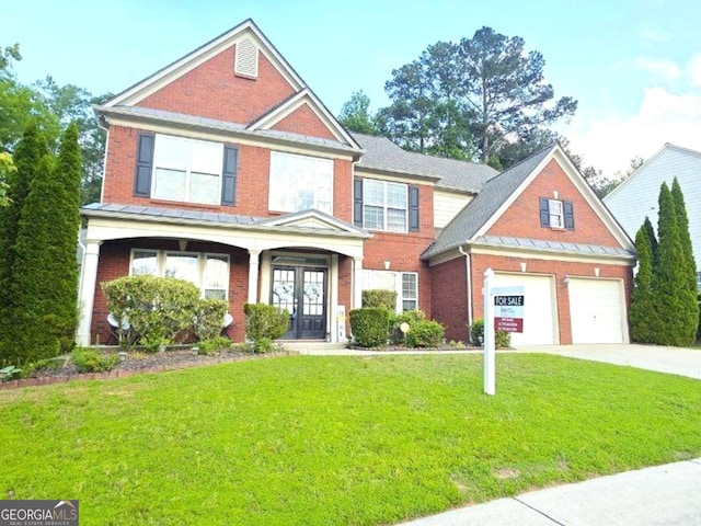 779 Avonley Creek Trce, Buford, GA 30518 - view of front of home featuring brick siding, driveway, french doors, and a front yard