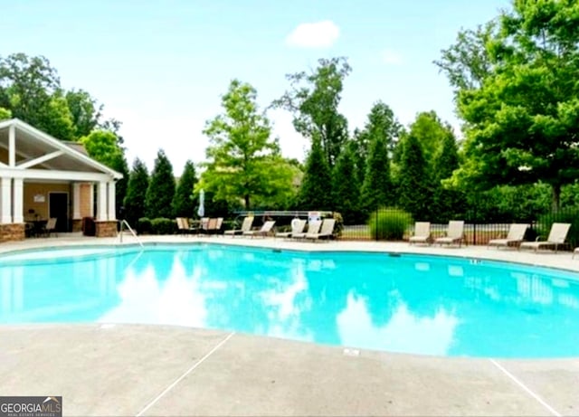 779 Avonley Creek Trce, Buford, GA 30518 - community pool with a patio area and view of wooded area