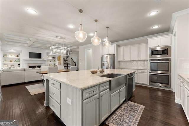 3317 Sweetleaf Ln, Buford, GA 30519 - kitchen featuring a sink, stainless steel appliances, dark wood-style floors, recessed lighting, and a fireplace