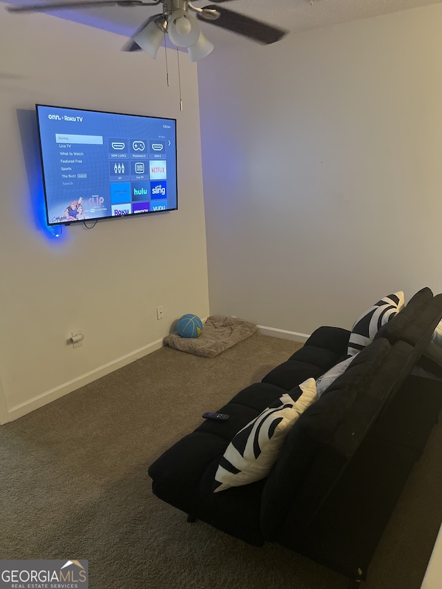 1263 Brookstone Rd, Atlanta, GA 30349 - cinema room featuring carpet flooring, ceiling fan, and baseboards