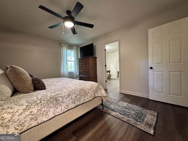 353 Lewis Cir, Commerce, GA 30529 - bedroom with dark wood-type flooring, a ceiling fan, and baseboards
