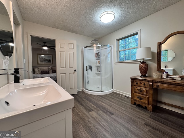 353 Lewis Cir, Commerce, GA 30529 - ensuite bathroom with a shower stall, wood finished floors, vanity, a textured ceiling, and a ceiling fan