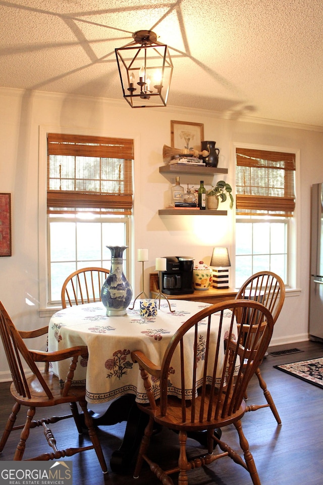 353 Lewis Cir, Commerce, GA 30529 - dining space featuring crown molding, plenty of natural light, a textured ceiling, dark wood finished floors, and baseboards