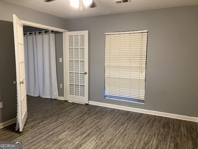 2119 Pine Heights Dr NE, Atlanta, GA 30324 - unfurnished room with dark wood-type flooring, baseboards, and a ceiling fan