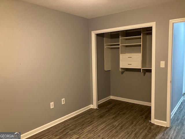 2119 Pine Heights Dr NE, Atlanta, GA 30324 - unfurnished bedroom featuring dark wood-style floors, baseboards, and a closet