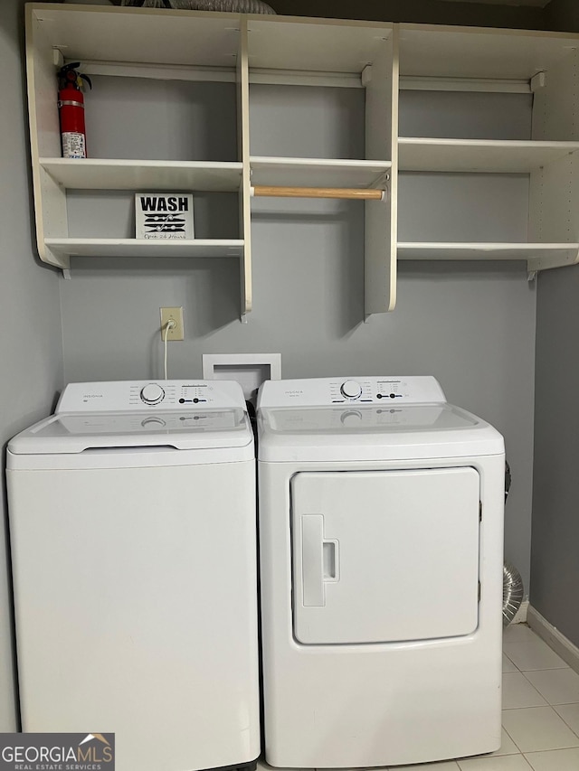 2119 Pine Heights Dr NE, Atlanta, GA 30324 - laundry room featuring independent washer and dryer, tile patterned floors, and baseboards