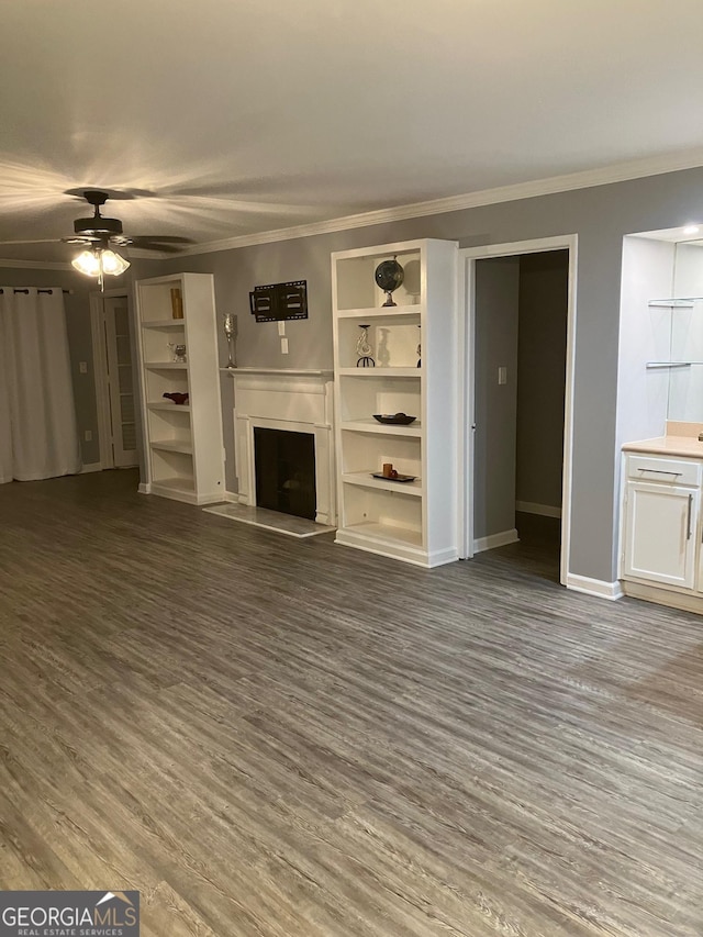 2119 Pine Heights Dr NE, Atlanta, GA 30324 - unfurnished living room with a fireplace with raised hearth, wood finished floors, ceiling fan, baseboards, and crown molding