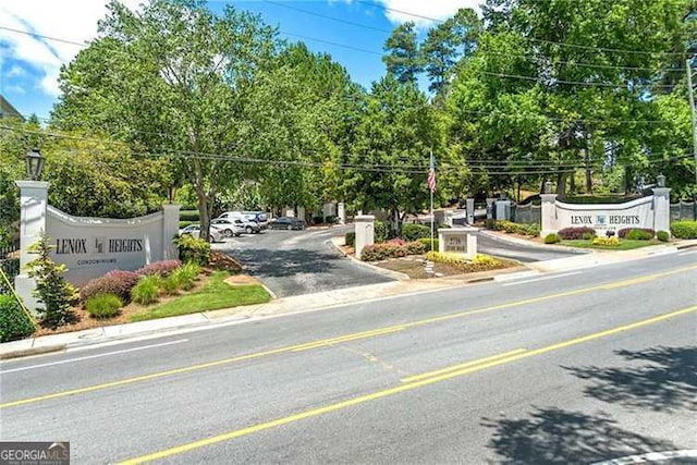 2119 Pine Heights Dr NE, Atlanta, GA 30324 - view of asphalt street with curbs, view of wooded area, and sidewalks