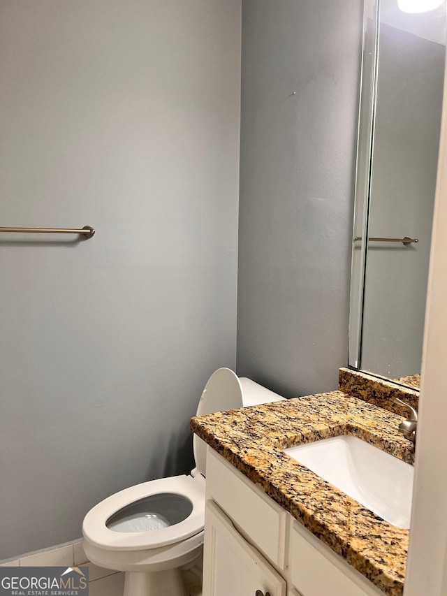 2119 Pine Heights Dr NE, Atlanta, GA 30324 - bathroom with toilet, vanity, and tile patterned flooring