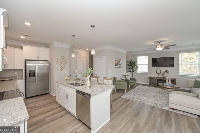 2861 Fareed Unit 40, Douglasville, GA 30135 - kitchen with stainless steel appliances, a sink, open floor plan, crown molding, and white cabinetry