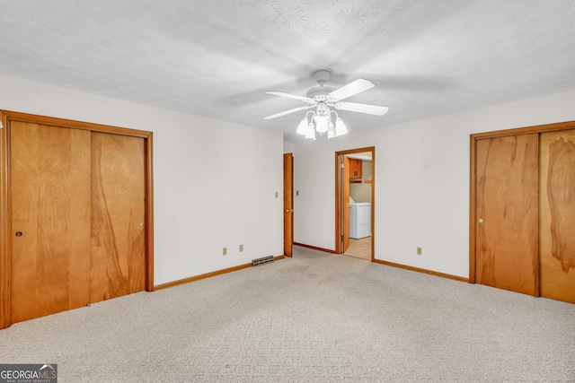 4911 Old Douglasville Rd, Lithia Springs, GA 30122 - unfurnished bedroom featuring washer / dryer, multiple closets, carpet flooring, baseboards, and connected bathroom