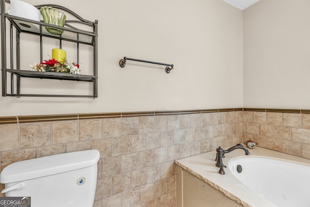 4911 Old Douglasville Rd, Lithia Springs, GA 30122 - full bath featuring a bath, toilet, wainscoting, and tile walls