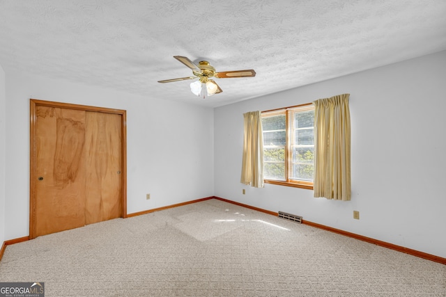 4911 Old Douglasville Rd, Lithia Springs, GA 30122 - carpeted empty room with baseboards, a ceiling fan, and a textured ceiling