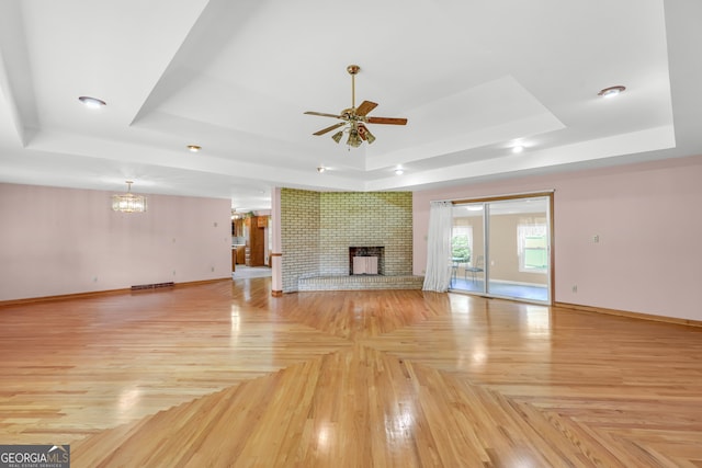 4911 Old Douglasville Rd, Lithia Springs, GA 30122 - unfurnished living room with a raised ceiling, baseboards, ceiling fan, a chandelier, and recessed lighting