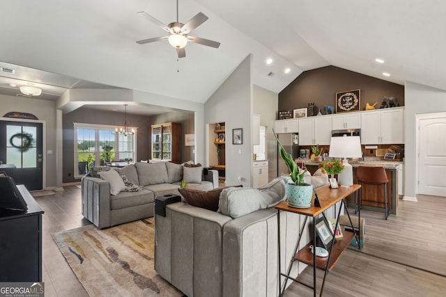 102 Bowline Ln, Kingsland, GA 31548 - living room featuring high vaulted ceiling, a ceiling fan, a chandelier, light wood-style flooring, and recessed lighting