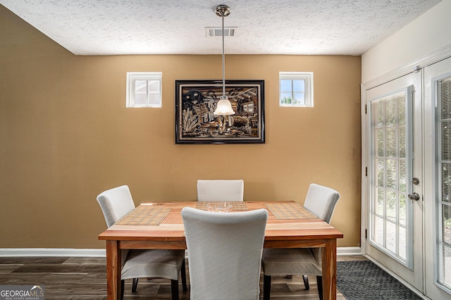855 Lakeside Cir, Covington, GA 30016 - dining room with baseboards, dark wood-type flooring, and a textured ceiling