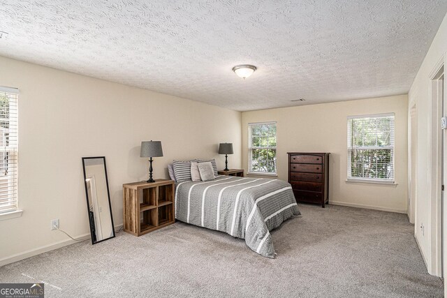 855 Lakeside Cir, Covington, GA 30016 - bedroom with carpet, baseboards, and a textured ceiling