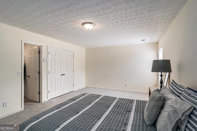 855 Lakeside Cir, Covington, GA 30016 - unfurnished bedroom featuring carpet flooring, baseboards, a closet, and a textured ceiling
