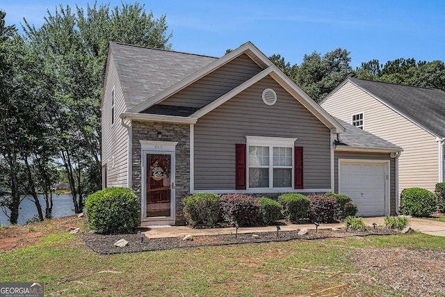 855 Lakeside Cir, Covington, GA 30016 - view of front of property with an attached garage, stone siding, driveway, and a front yard