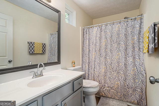 855 Lakeside Cir, Covington, GA 30016 - full bath with toilet, vanity, a textured ceiling, and a shower with shower curtain