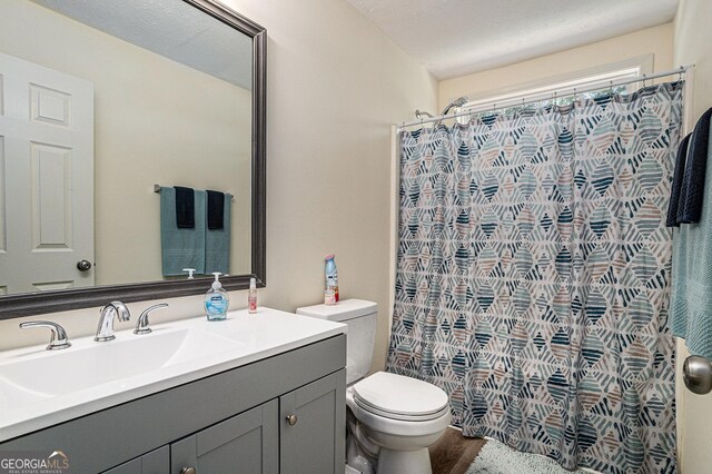 855 Lakeside Cir, Covington, GA 30016 - full bathroom featuring vanity, toilet, a shower with shower curtain, and wood finished floors
