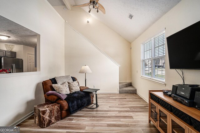 855 Lakeside Cir, Covington, GA 30016 - living area featuring a textured ceiling, ceiling fan, light wood-style floors, baseboards, and high vaulted ceiling