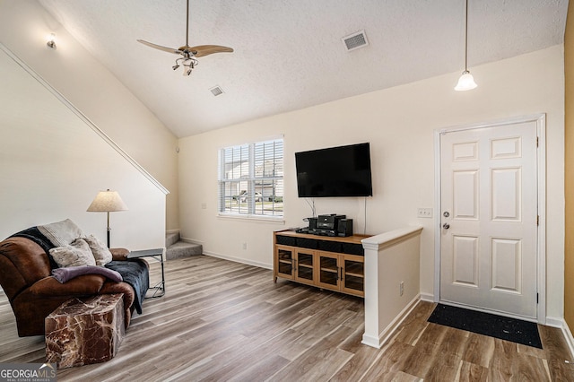 855 Lakeside Cir, Covington, GA 30016 - living area with wood finished floors, a textured ceiling, ceiling fan, baseboards, and high vaulted ceiling