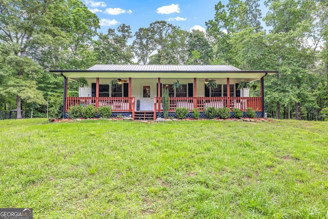 751 Hawkins Rd, Homer, GA 30547 - view of front facade with ceiling fan, covered porch, a front lawn, and metal roof