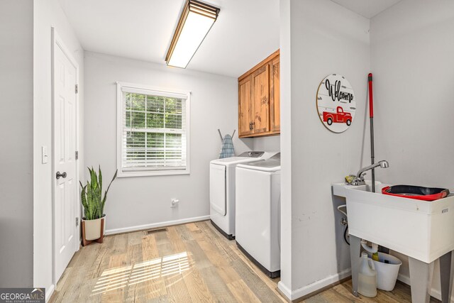 751 Hawkins Rd, Homer, GA 30547 - washroom featuring cabinet space, washer and clothes dryer, light wood-type flooring, and baseboards