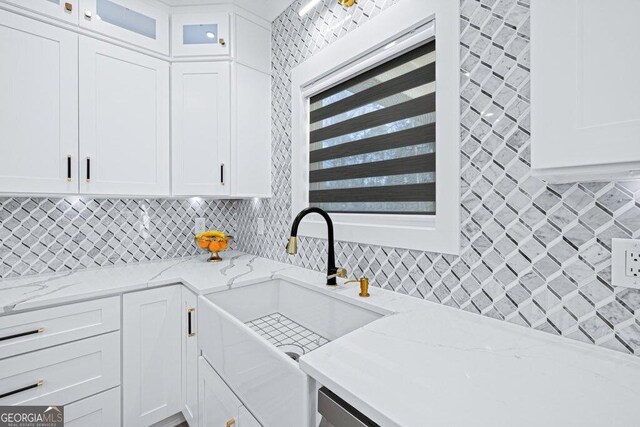 29 Cedar Blf, Winder, GA 30680 - kitchen with decorative backsplash, glass insert cabinets, white cabinets, and light stone countertops