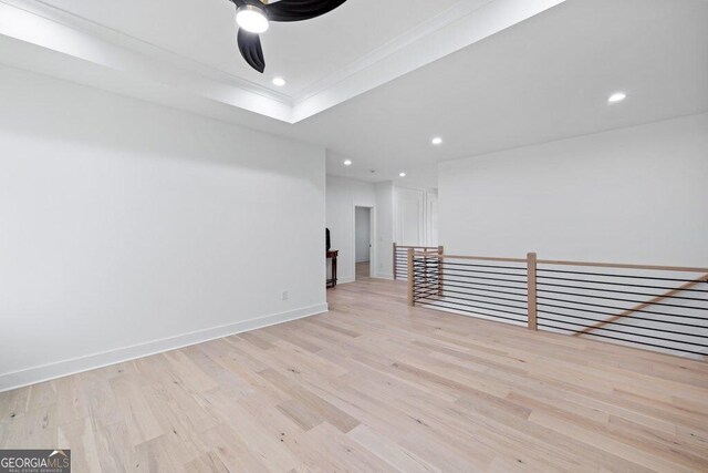 29 Cedar Blf, Winder, GA 30680 - empty room with light wood-type flooring, ceiling fan, recessed lighting, ornamental molding, and a tray ceiling