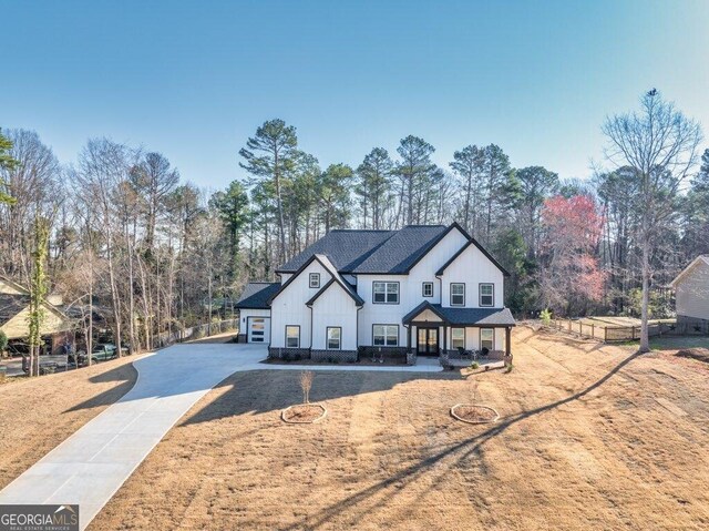 29 Cedar Blf, Winder, GA 30680 - modern farmhouse style home with concrete driveway, board and batten siding, and view of wooded area