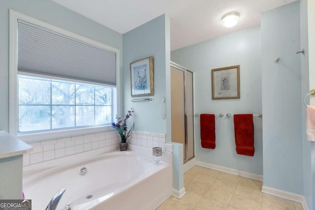 239 Taylors Farm Dr, Canton, GA 30115 - bathroom with a garden tub, a stall shower, tile patterned flooring, and baseboards