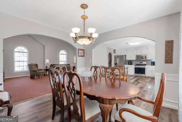 239 Taylors Farm Dr, Canton, GA 30115 - dining room with arched walkways, a chandelier, and wood finished floors