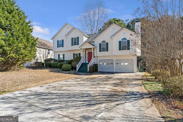 239 Taylors Farm Dr, Canton, GA 30115 - view of front of home featuring a garage, driveway, and a chimney