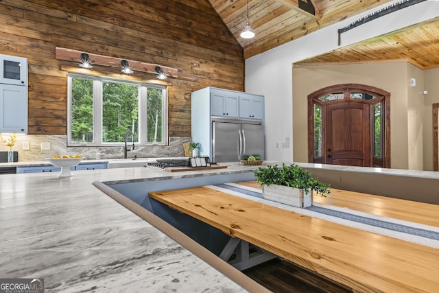 795 E Jones Chapel Rd, Danielsville, GA 30633 - kitchen featuring wooden ceiling, stainless steel appliances, backsplash, light stone countertops, and wooden walls