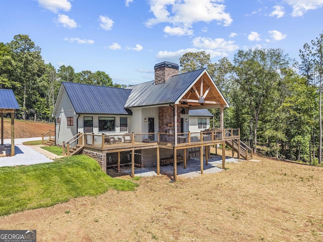 795 E Jones Chapel Rd, Danielsville, GA 30633 - rear view of property with stairs, a metal roof, a wooden deck, a chimney, and a yard