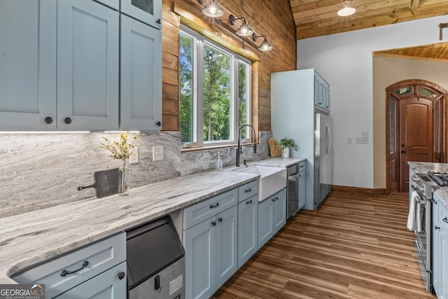 795 E Jones Chapel Rd, Danielsville, GA 30633 - kitchen featuring appliances with stainless steel finishes, tasteful backsplash, dark wood-style flooring, light stone countertops, and vaulted ceiling