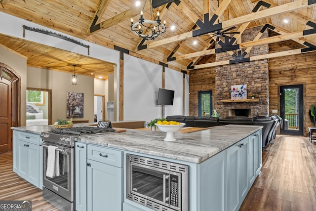 795 E Jones Chapel Rd, Danielsville, GA 30633 - kitchen featuring appliances with stainless steel finishes, a wood ceiling with exposed beams, wood finished floors, open floor plan, and a fireplace
